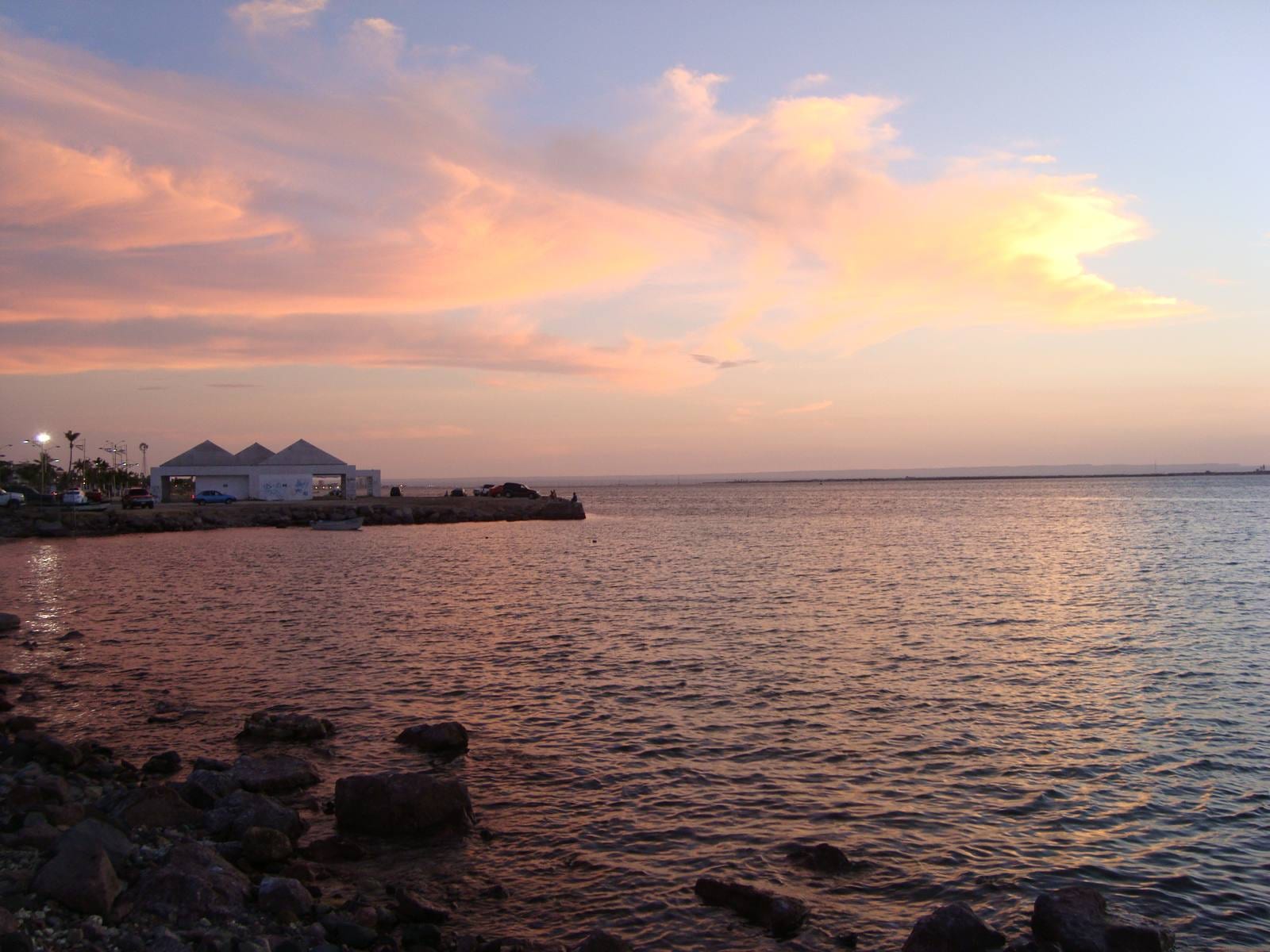 Vista del malecón de La Paz, Baja California Sur, al atardecer, con el mar en calma frente a la costa.
